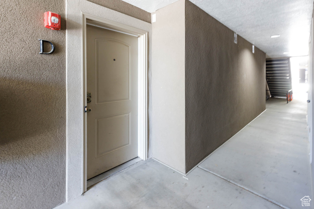 Doorway to property featuring stucco siding
