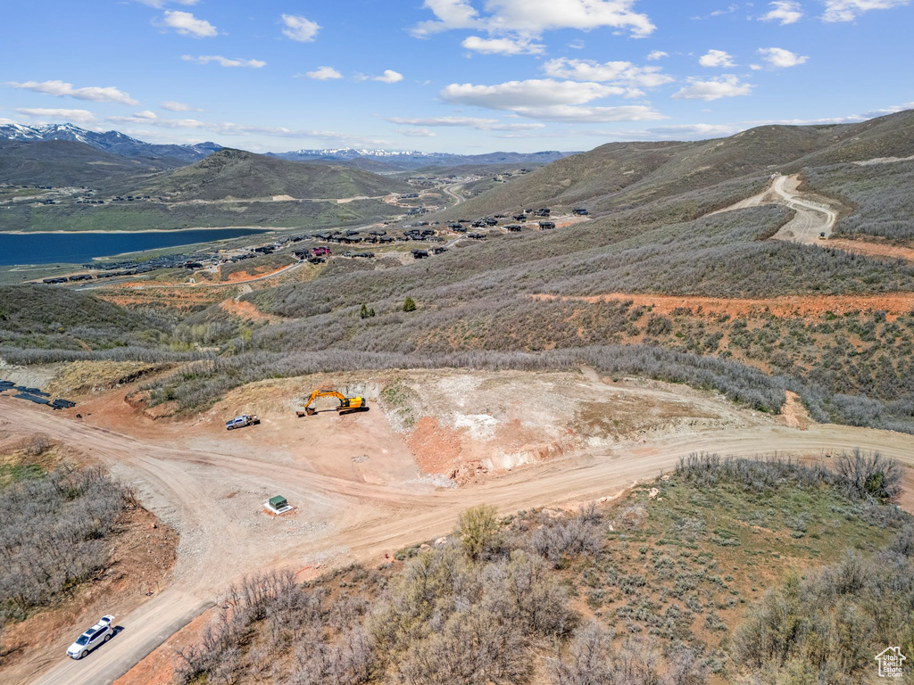 Drone / aerial view featuring a water and mountain view
