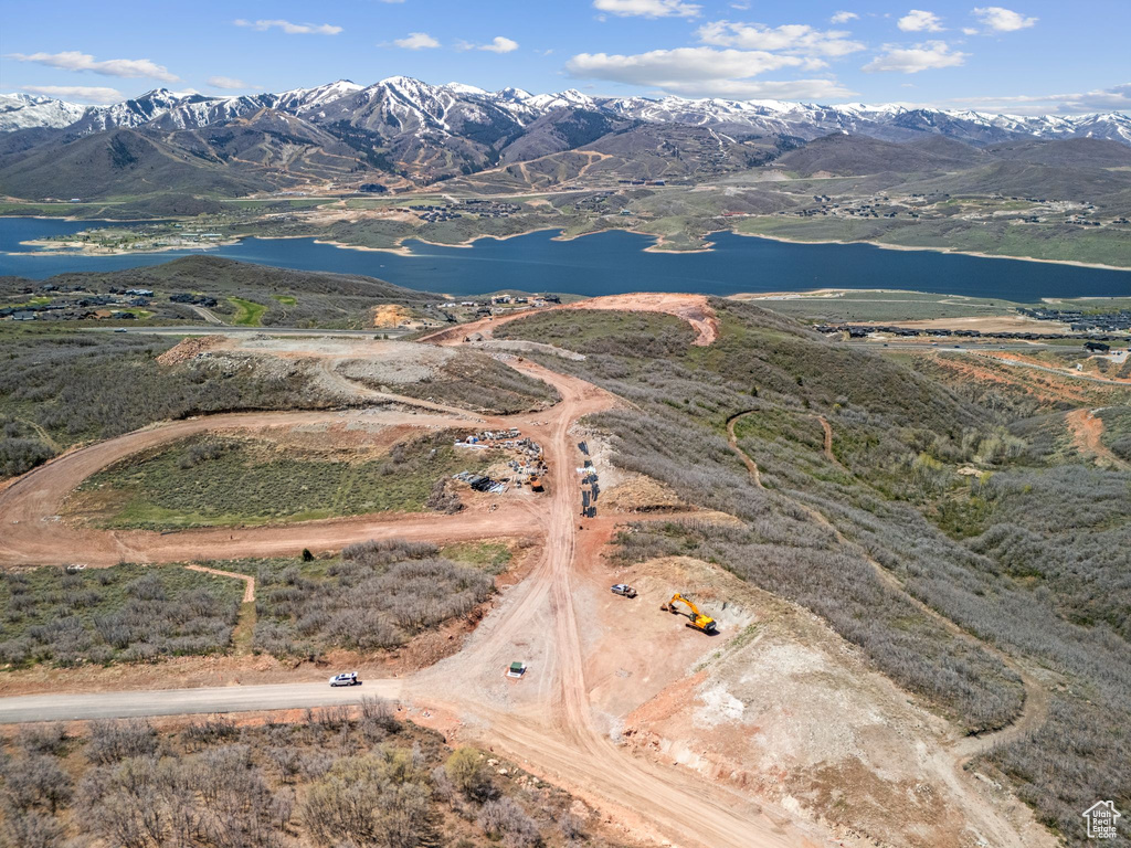 Birds eye view of property with a water and mountain view