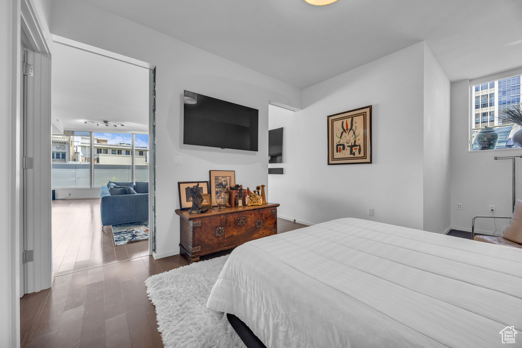 Bedroom featuring baseboards and dark wood-style floors