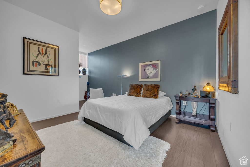 Bedroom featuring wood finished floors and baseboards
