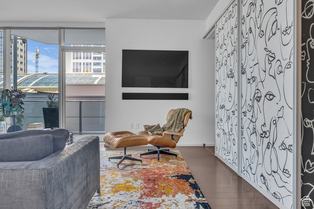 Living area with baseboards and wood finished floors