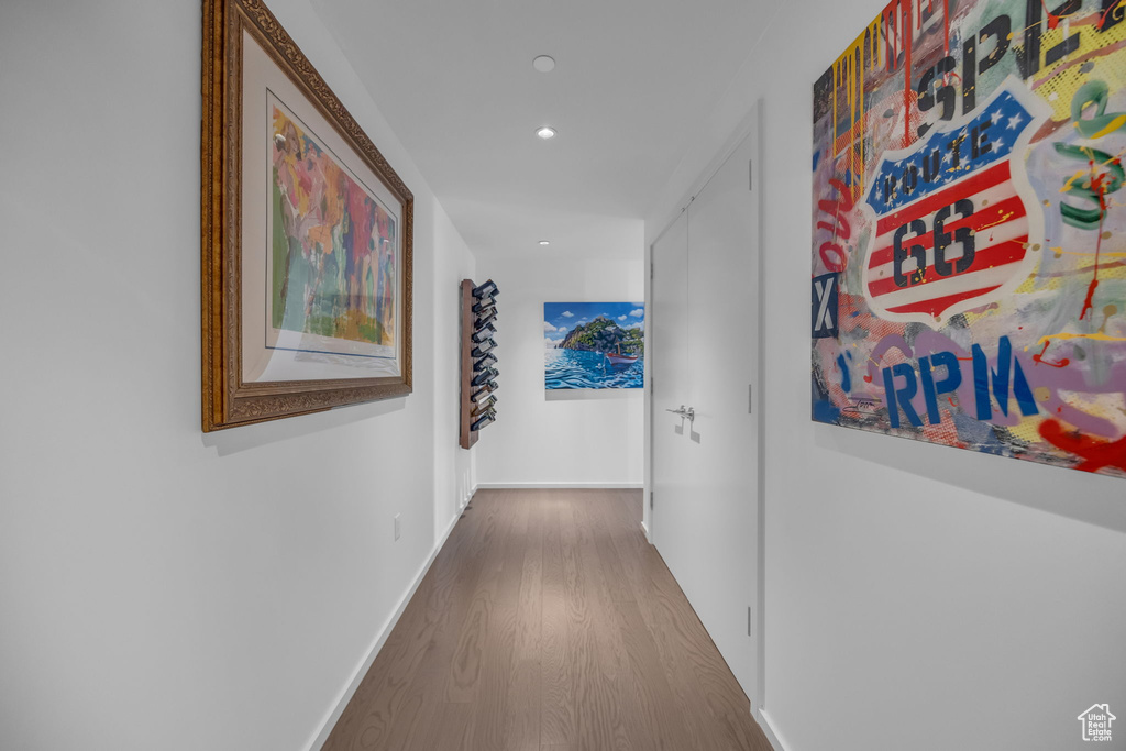 Corridor with baseboards, recessed lighting, and wood finished floors