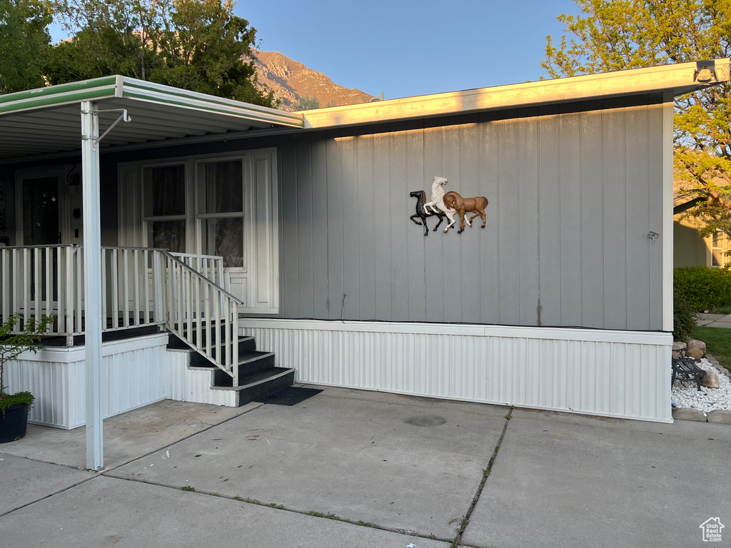 Doorway to property featuring covered porch and a mountain view