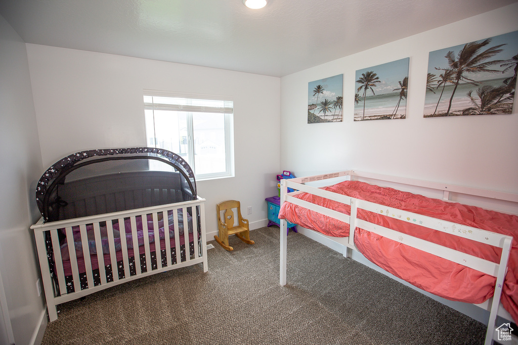 Bedroom with baseboards and carpet floors