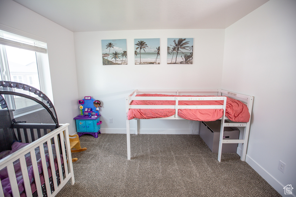 Unfurnished bedroom featuring carpet and baseboards