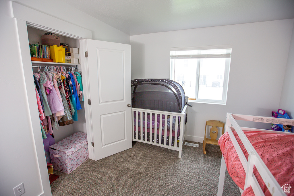 Bedroom featuring baseboards, carpet floors, a closet, and visible vents