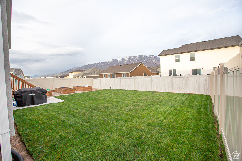 View of yard with a mountain view and a fenced backyard