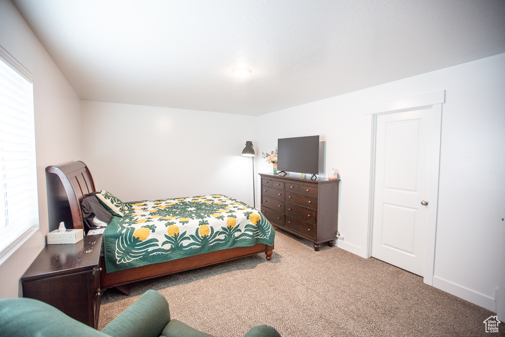 Carpeted bedroom with baseboards