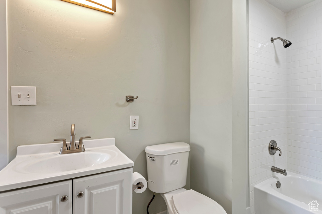 Full bathroom featuring vanity, toilet, and  shower combination