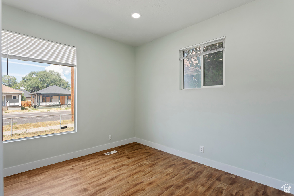 Spare room with recessed lighting, baseboards, visible vents, and wood finished floors
