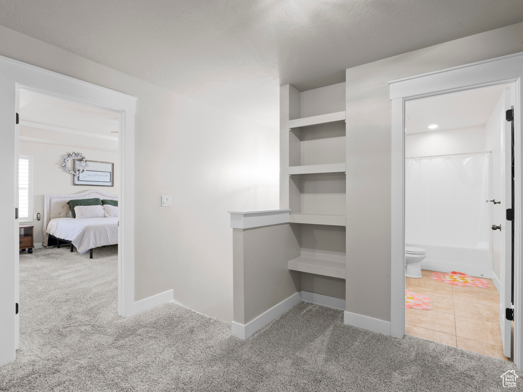 Hall with baseboards and carpet floors