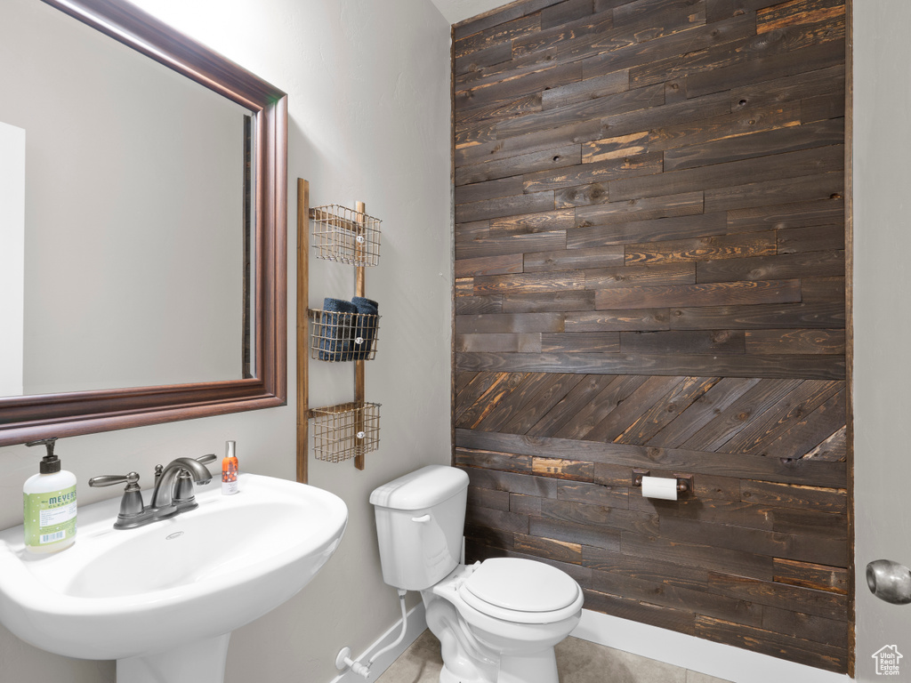 Bathroom with toilet, baseboards, and a sink