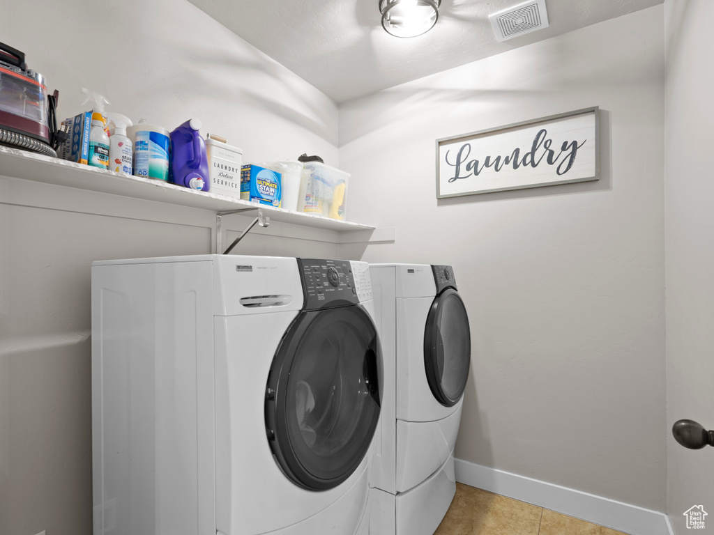 Laundry room featuring baseboards, laundry area, visible vents, and washer and dryer