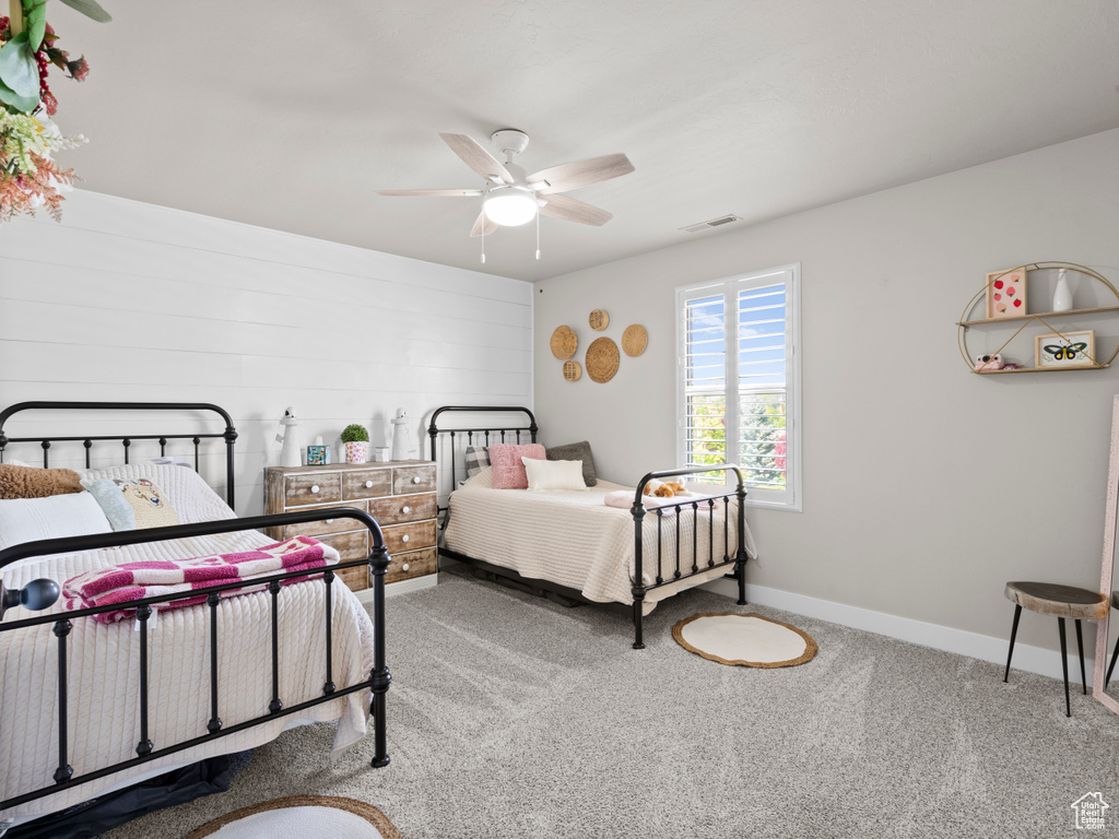 Bedroom with carpet, visible vents, baseboards, and ceiling fan