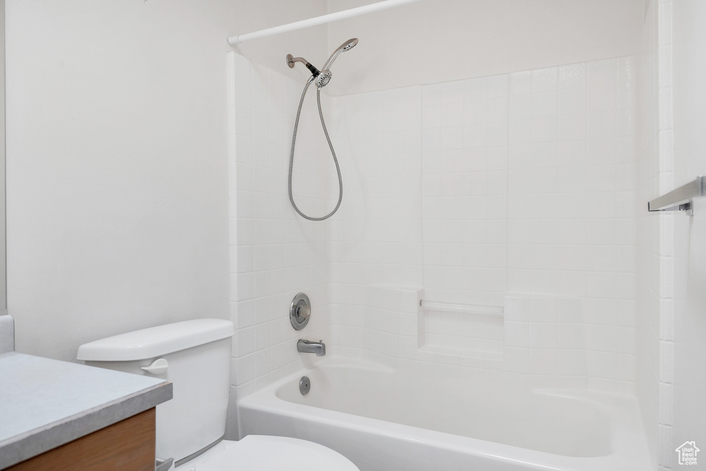 Bathroom featuring vanity, toilet, and tub / shower combination