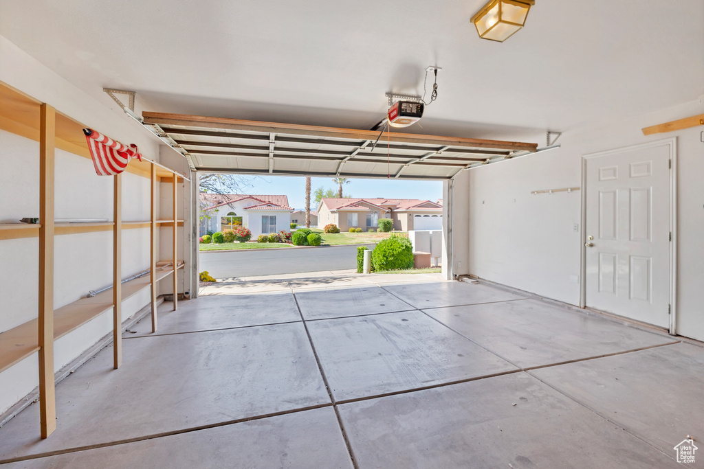 Garage with a residential view and a garage door opener
