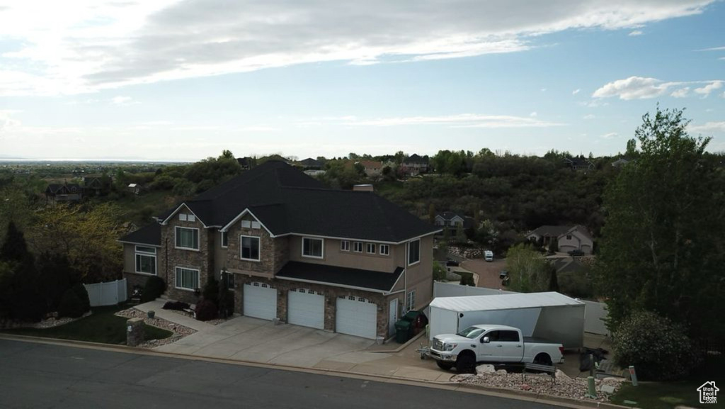View of front facade featuring an attached garage and driveway