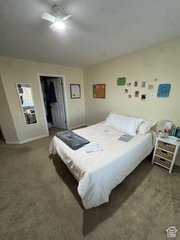 Bedroom with baseboards, a closet, a ceiling fan, and carpet floors