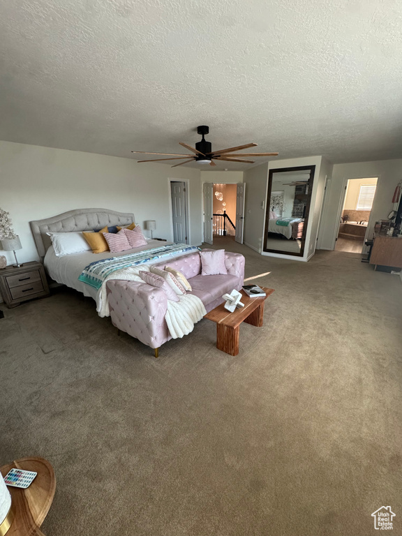 Bedroom with carpet, a textured ceiling, and ceiling fan