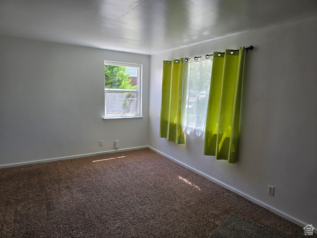 Empty room with baseboards and carpet