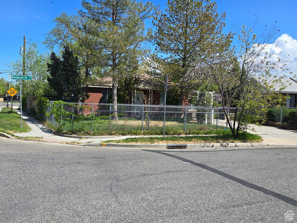 View of property hidden behind natural elements with fence