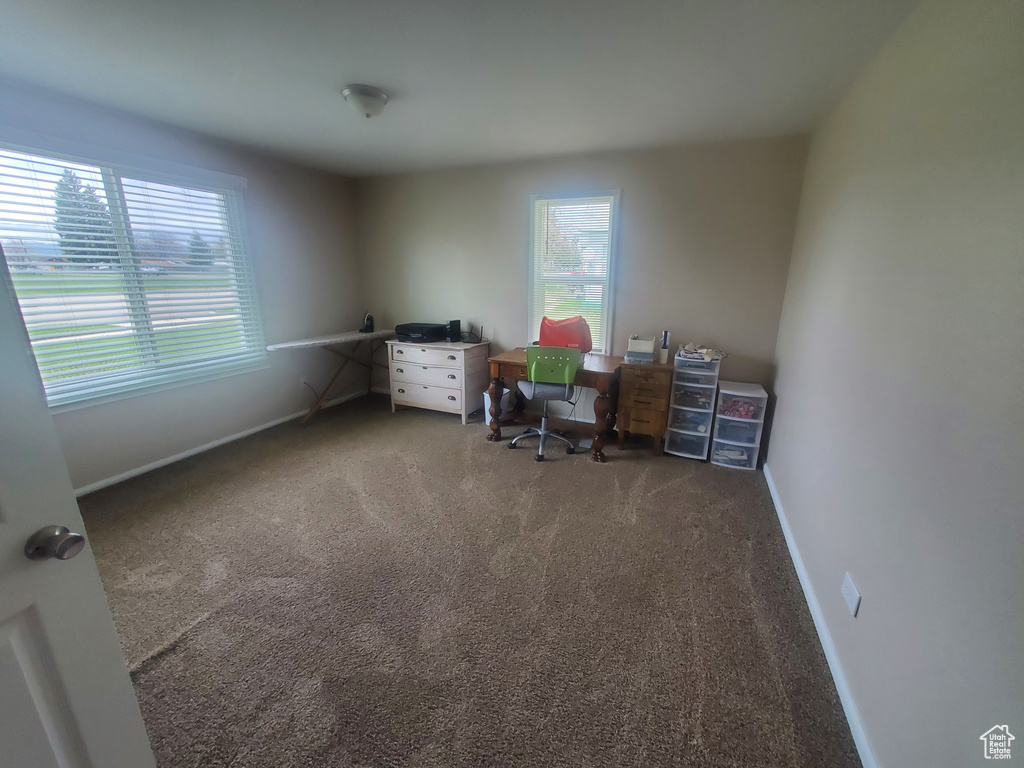 Carpeted office with baseboards