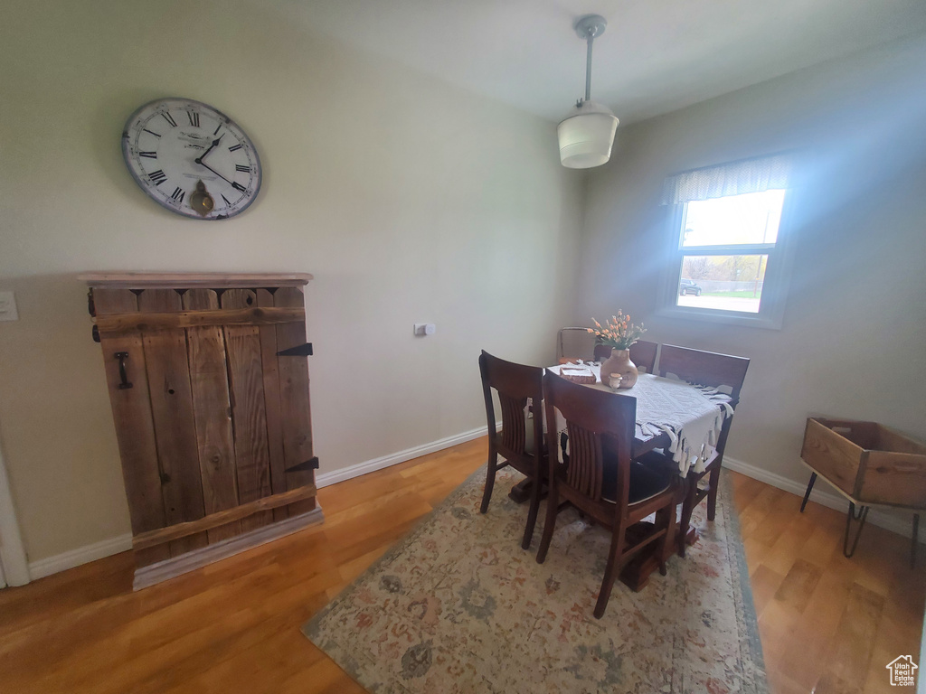 Dining space with wood finished floors and baseboards