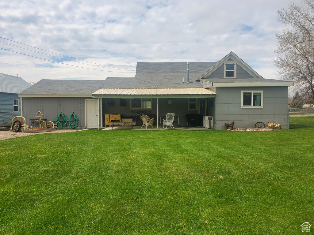 Rear view of house with a lawn