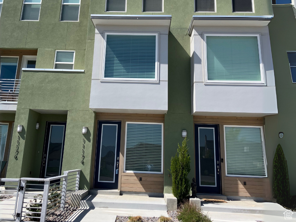 Rear view of property featuring stucco siding