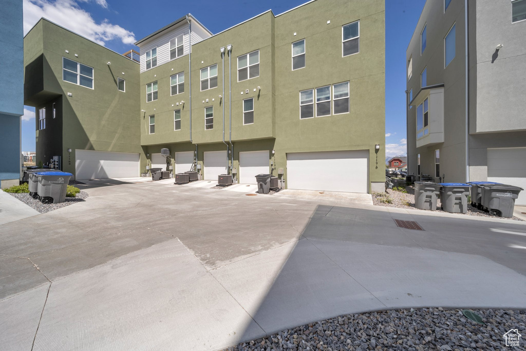 Exterior space featuring central AC unit and a garage