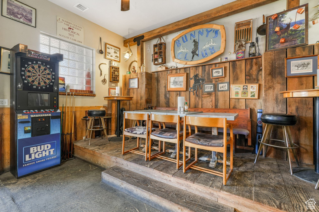 Dining area featuring visible vents and wooden walls