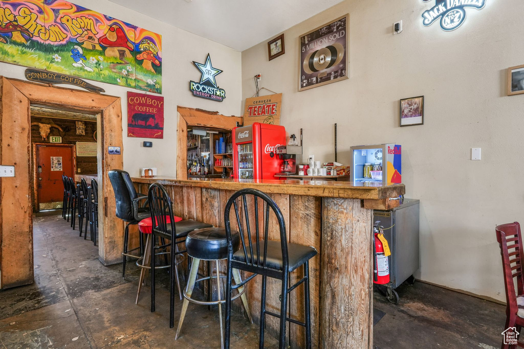 Bar featuring a bar and concrete flooring