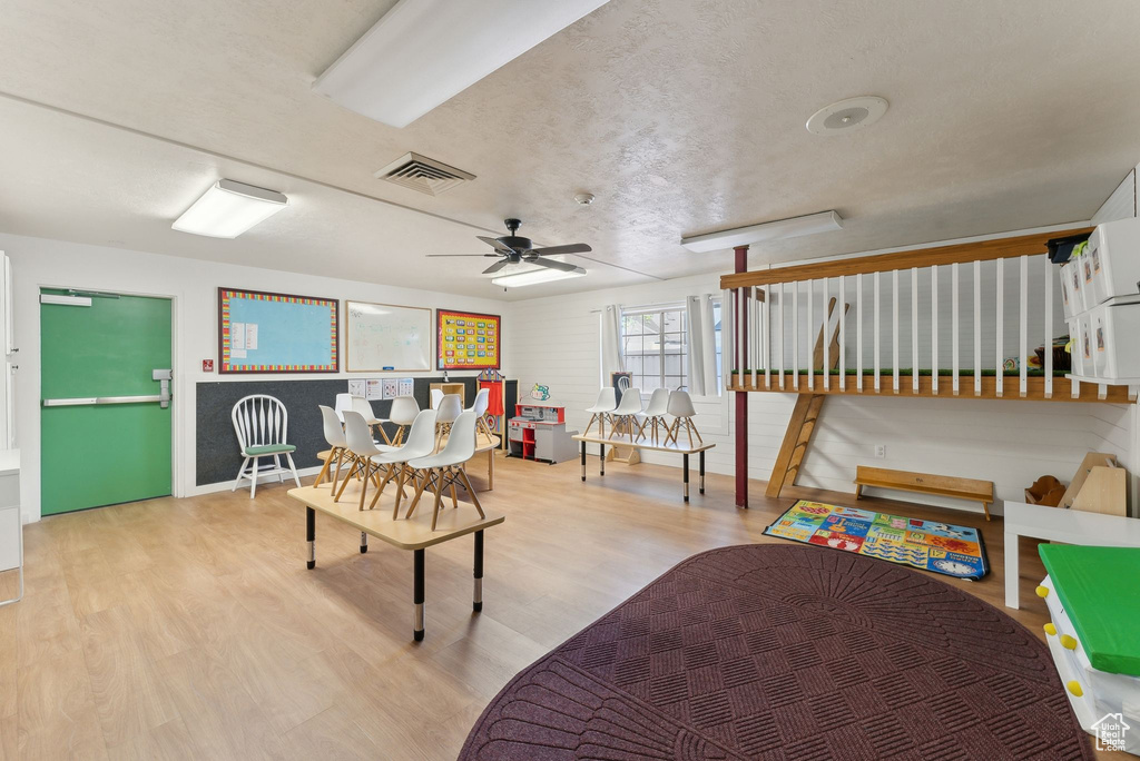 Living room featuring ceiling fan, baseboards, visible vents, and wood finished floors