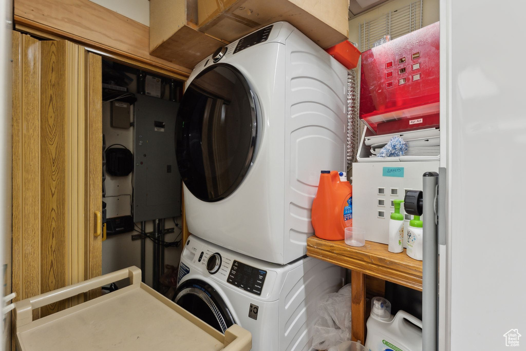 Washroom with stacked washer / dryer and laundry area