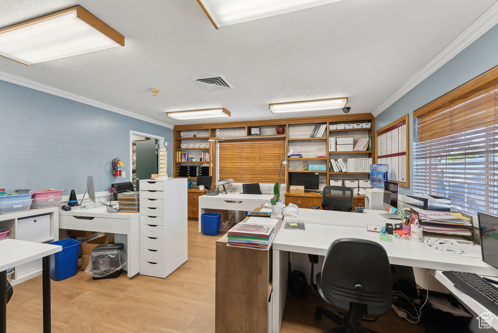 Home office featuring crown molding and visible vents