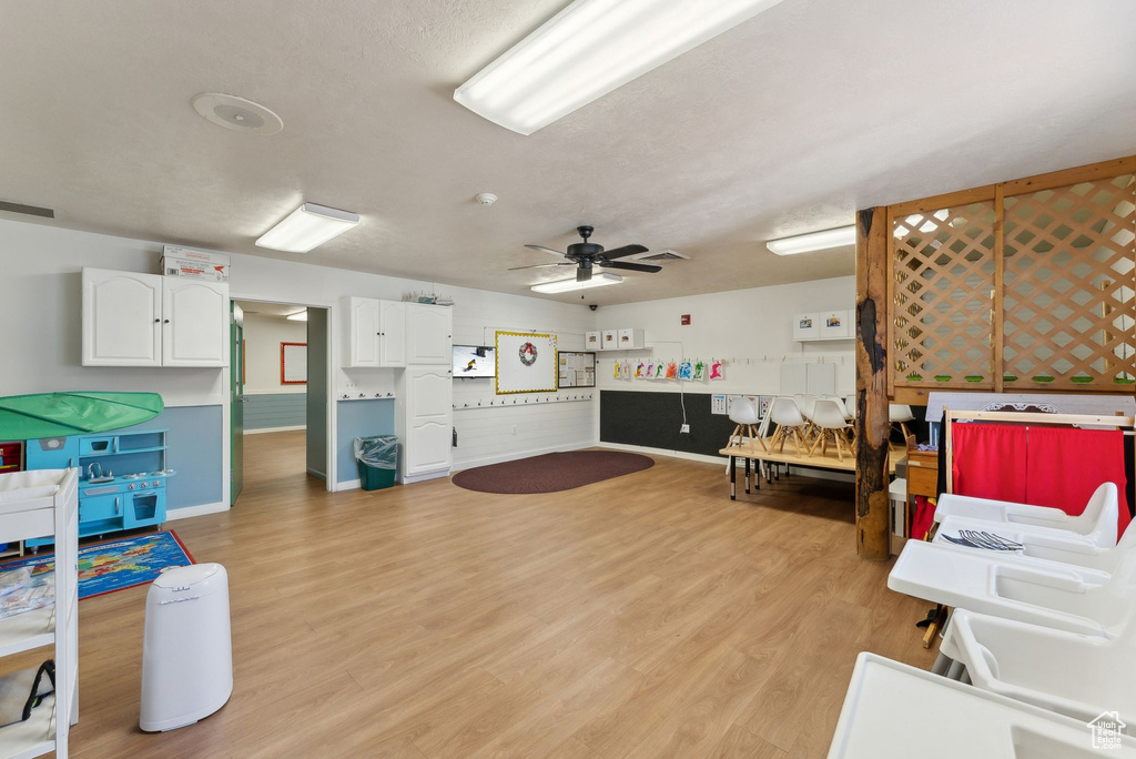 Interior space featuring baseboards, light wood-type flooring, a ceiling fan, and visible vents