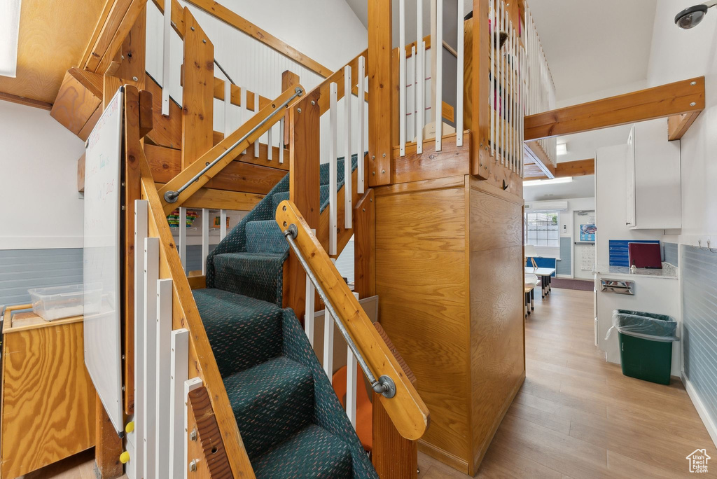 Stairway featuring baseboards and wood finished floors