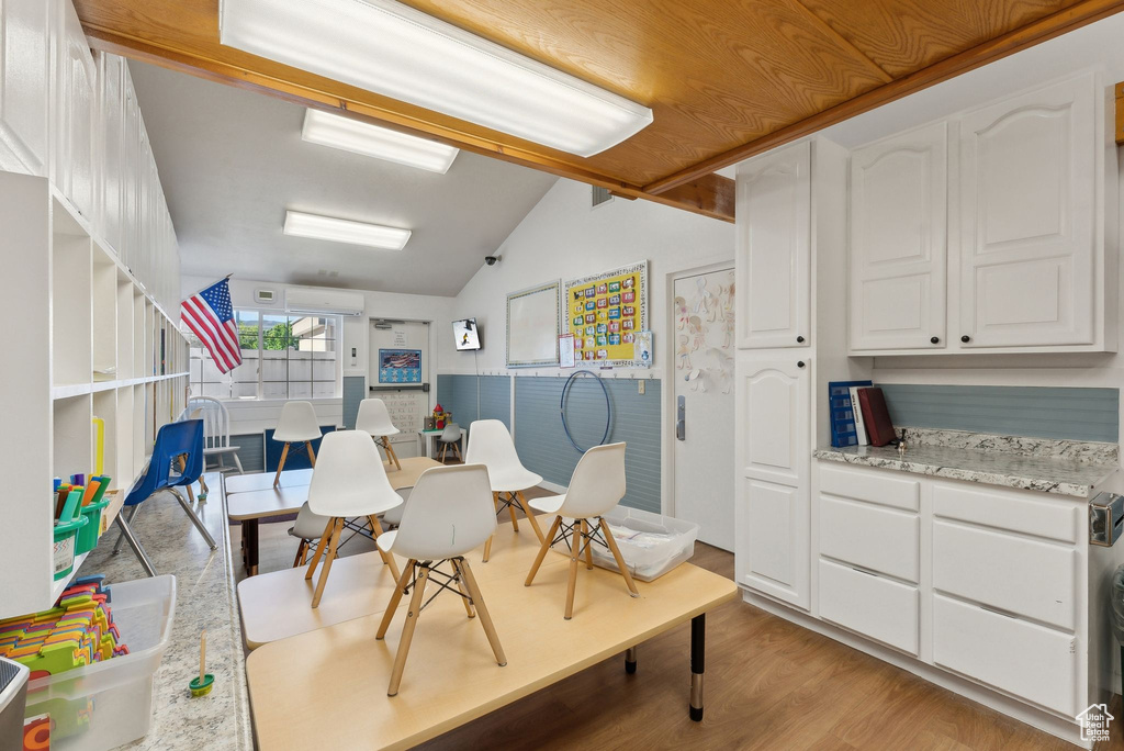 Dining space featuring light wood-style floors and lofted ceiling