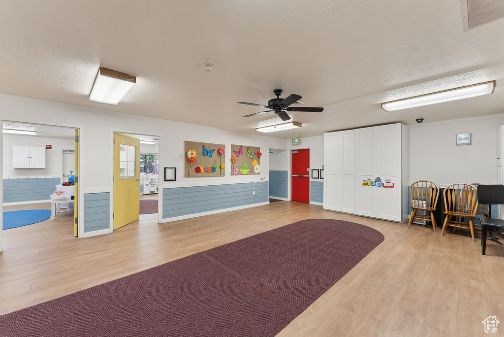 Interior space with a ceiling fan, light wood-style floors, and visible vents