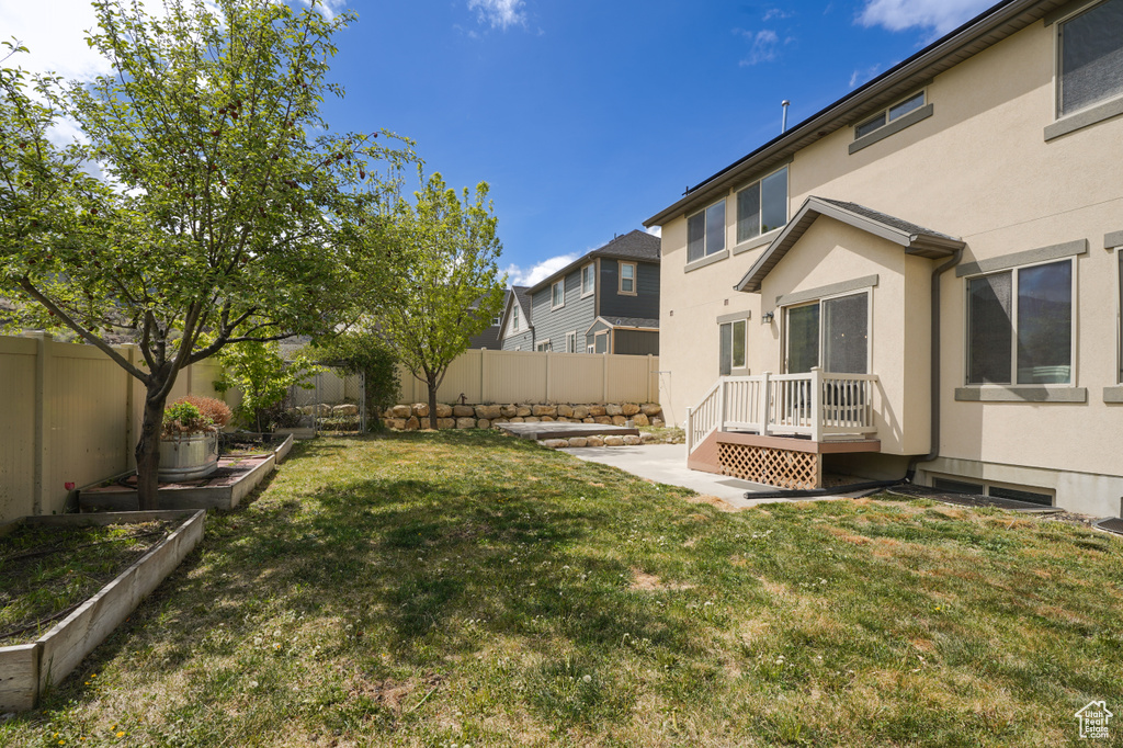 View of yard featuring a garden and a fenced backyard