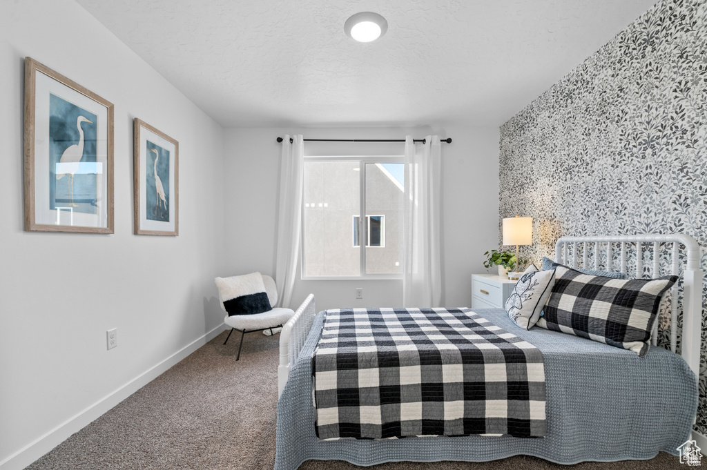 Carpeted bedroom with baseboards