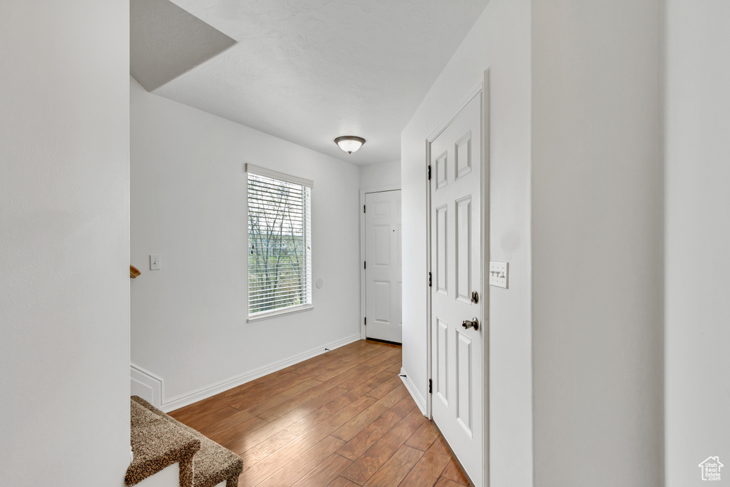 Hallway featuring baseboards and light wood-type flooring