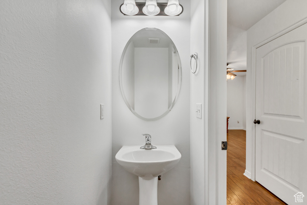 Bathroom featuring a sink and wood finished floors