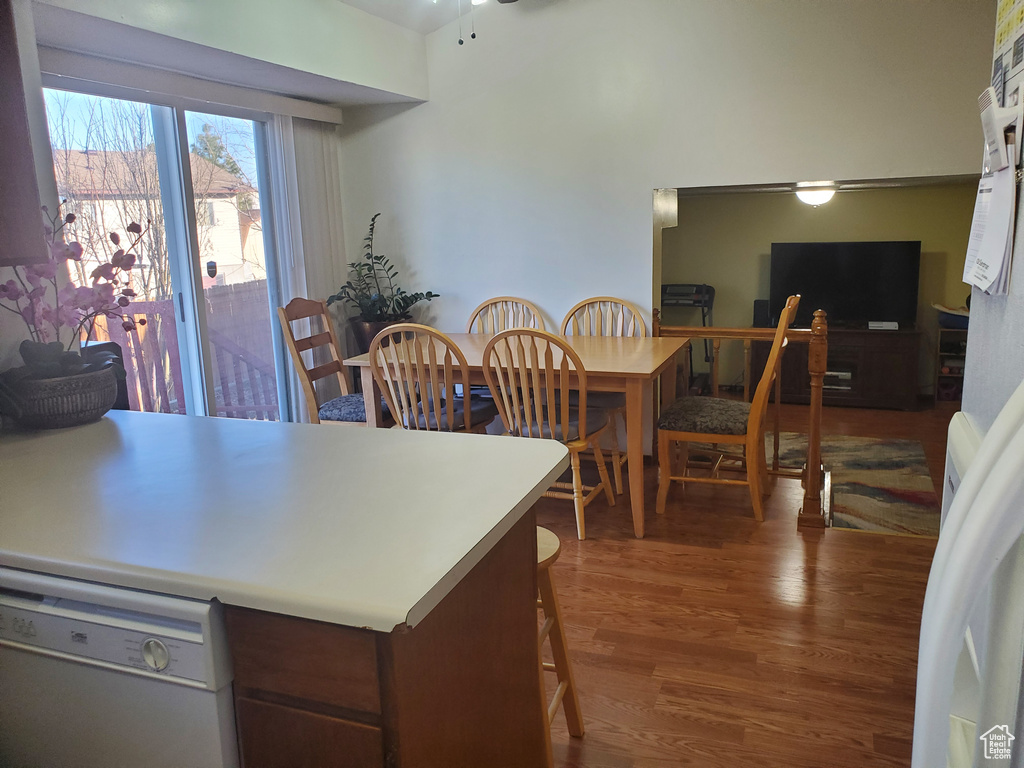 Kitchen featuring dishwasher, ceiling fan, a peninsula, wood finished floors, and light countertops