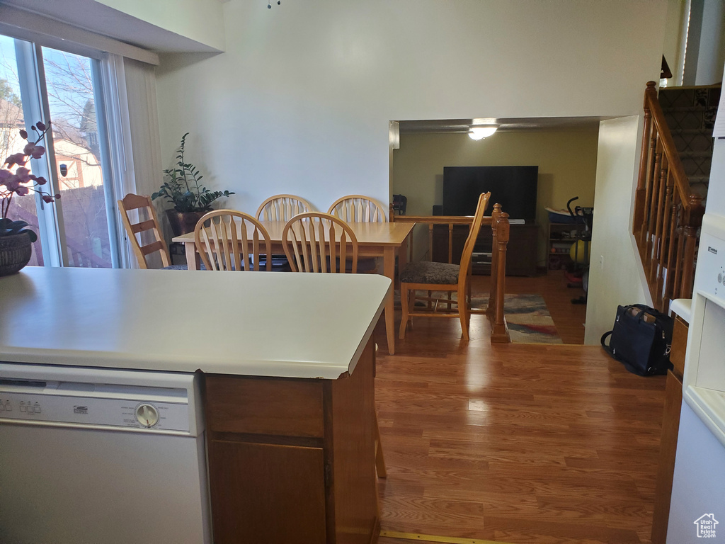 Kitchen with light countertops, white dishwasher, and wood finished floors