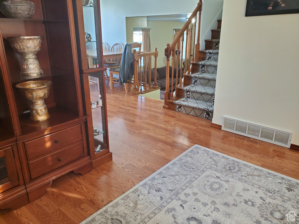 Interior space with stairs, visible vents, and wood finished floors