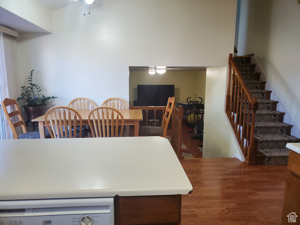 Dining area with stairway and wood finished floors