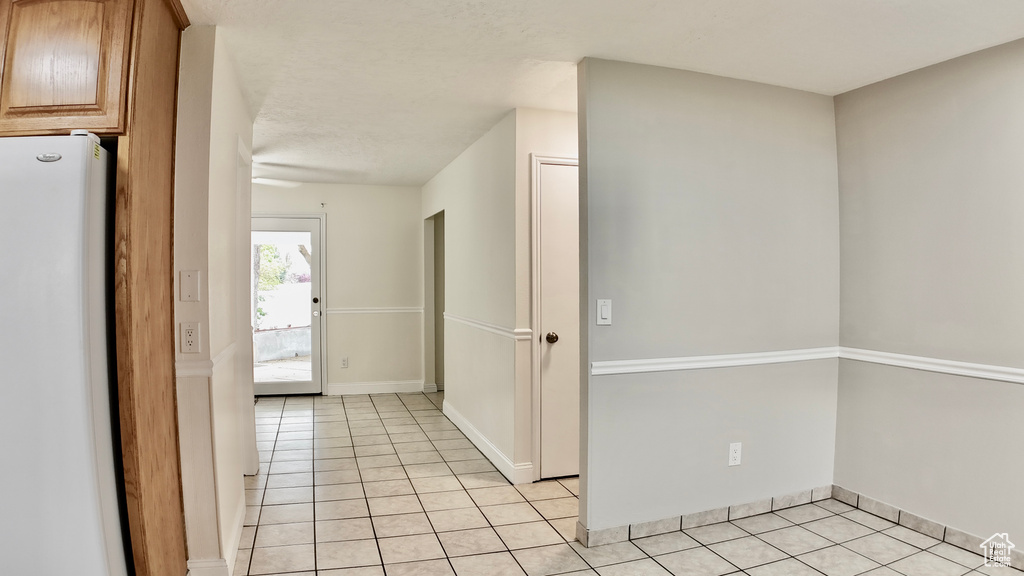 Interior space featuring light tile patterned floors and baseboards