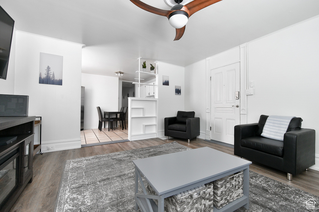 Living room featuring ceiling fan and wood finished floors